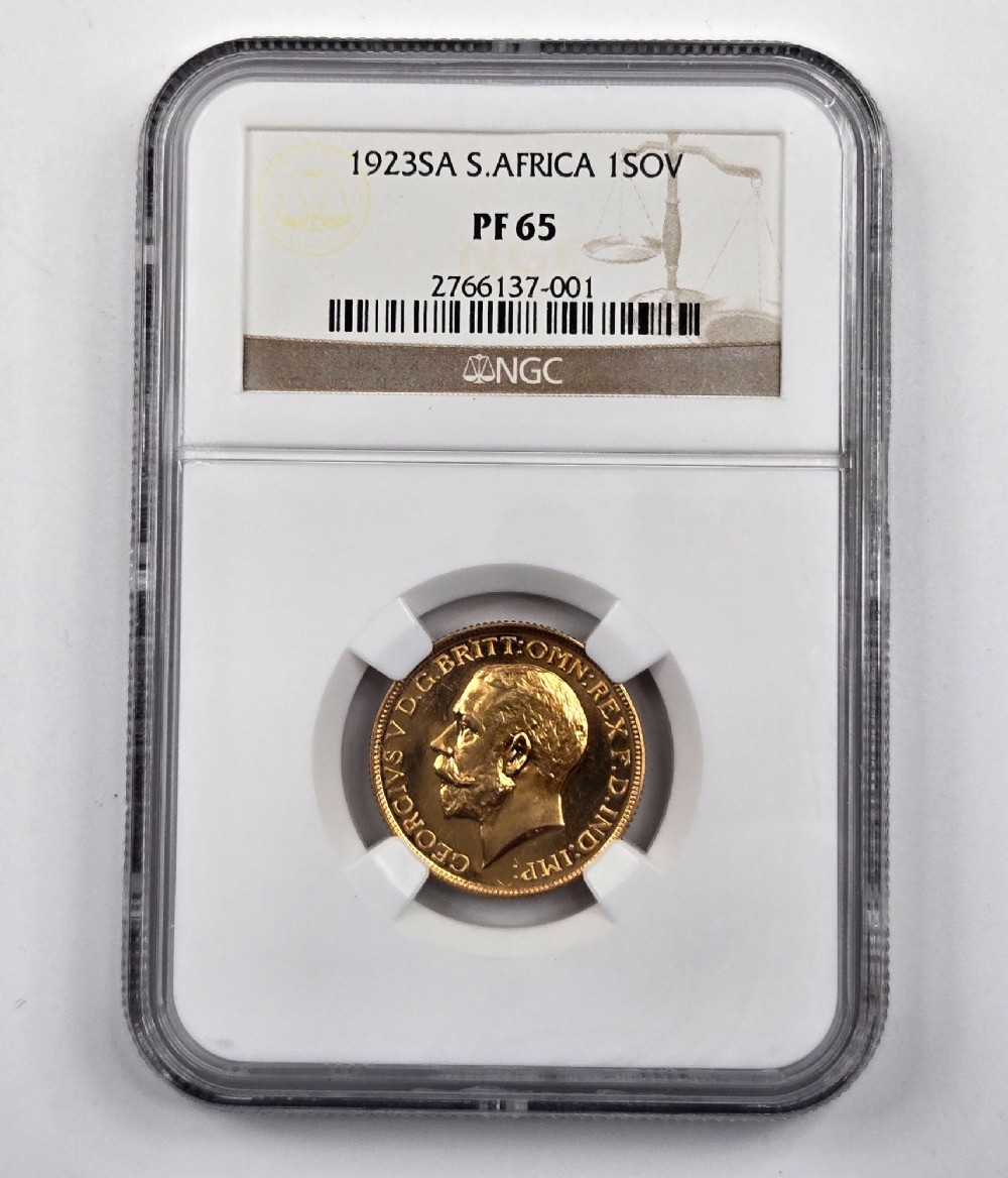 A 1923 South Africa gold sovereign coin featuring the bare head profile portrait of King George V, encapsulated in a white plastic NGC PF 65 grading slab. View III