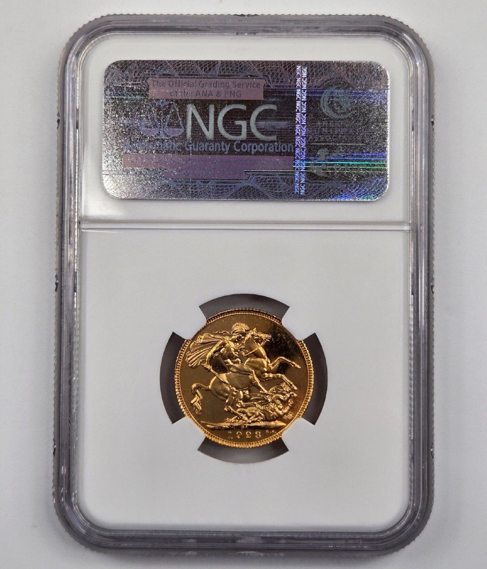 A 1923 South Africa gold sovereign coin featuring the bare head profile portrait of King George V, encapsulated in a white plastic NGC PF 65 grading slab. View IV
