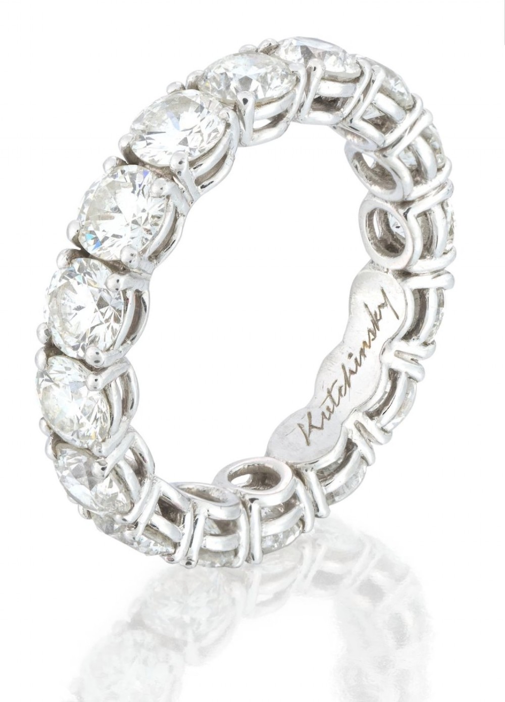 A platinum full eternity ring set with round brilliant diamonds, displayed inside its original black leather Kutchinsky box. View III