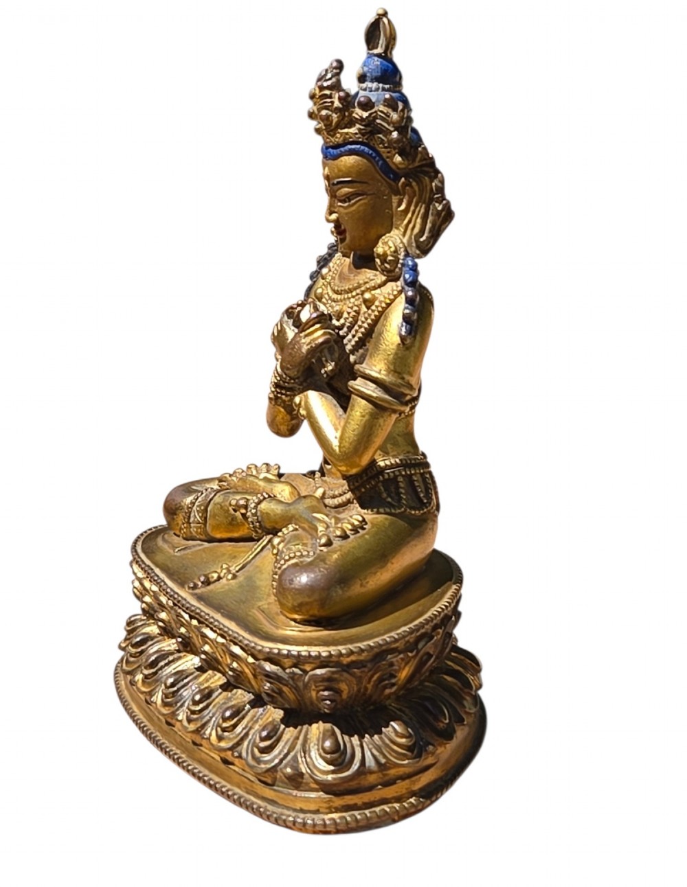 An 18th-century Sino-Tibetan gilt-bronze figure depicting the deity Vajradhara seated in meditation upon a double lotus pedestal. View IV