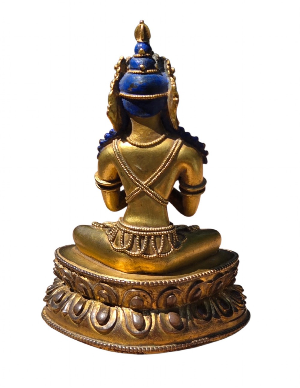 An 18th-century Sino-Tibetan gilt-bronze figure depicting the deity Vajradhara seated in meditation upon a double lotus pedestal. View V