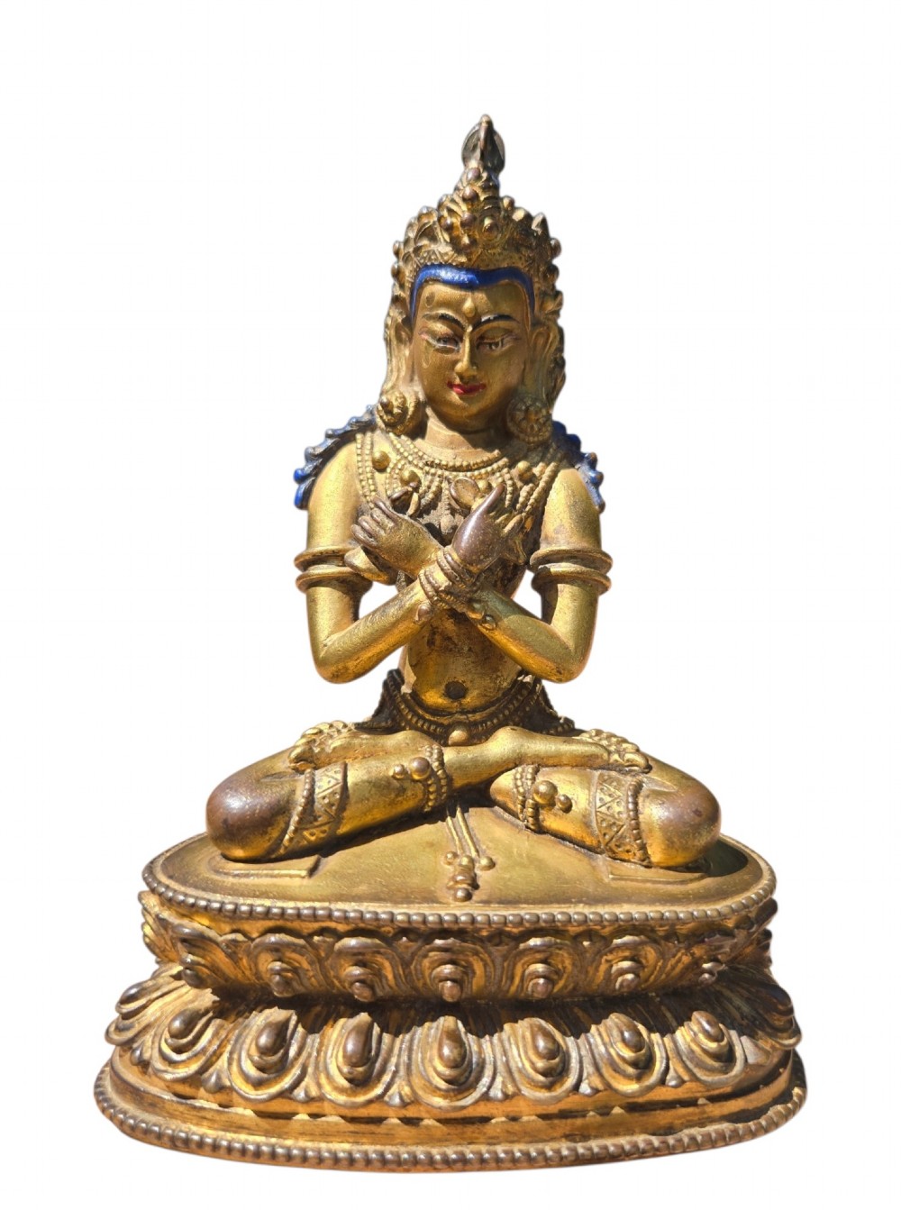 An 18th-century Sino-Tibetan gilt-bronze figure depicting the deity Vajradhara seated in meditation upon a double lotus pedestal. View VII
