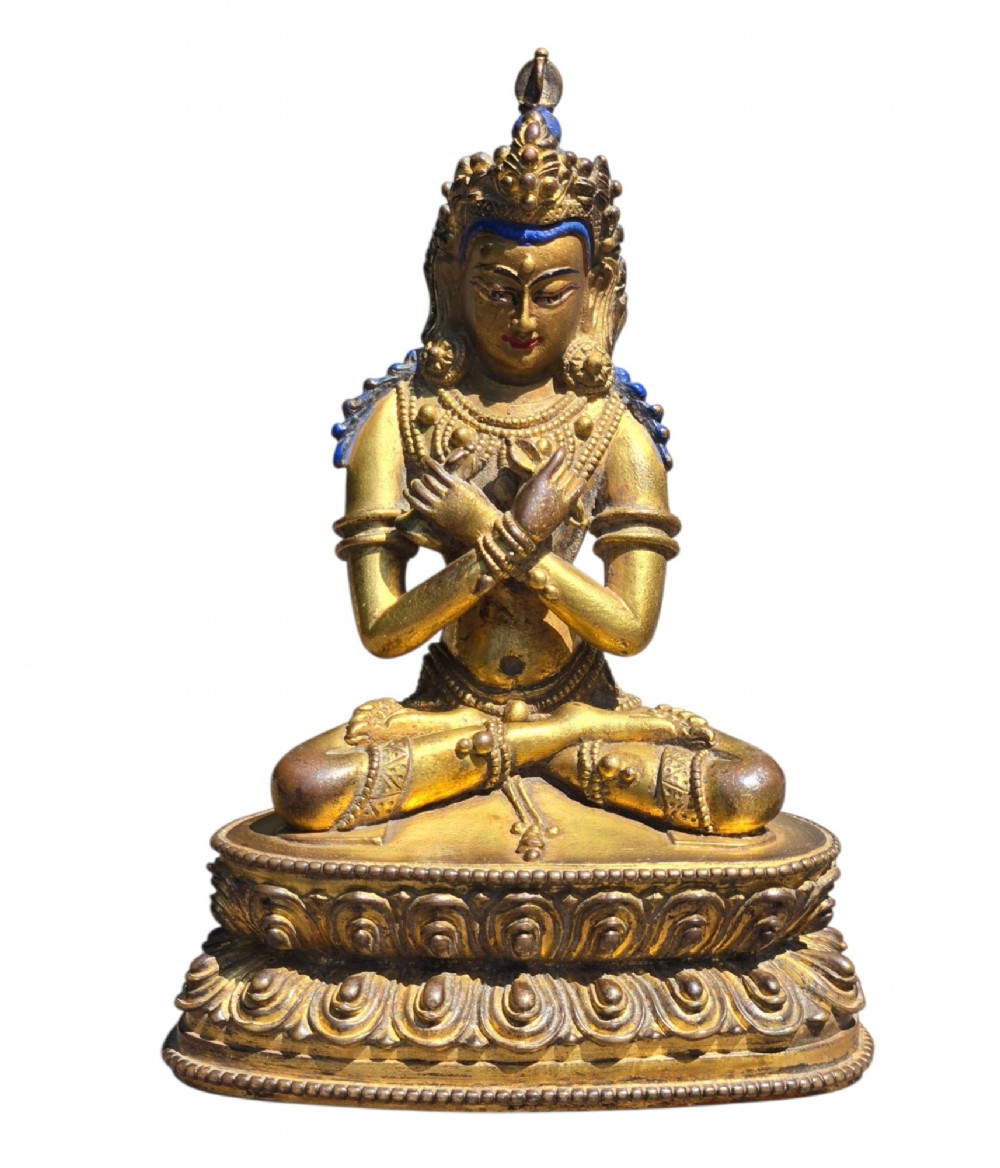 An 18th-century Sino-Tibetan gilt-bronze figure depicting the deity Vajradhara seated in meditation upon a double lotus pedestal. View XI