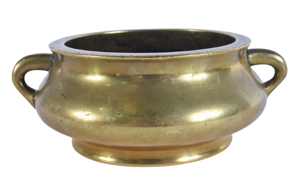 An 18th-century cast bronze incense burner featuring a compressed rounded body, flared rim, two loop handles, and a burnished golden patinated finish. View III