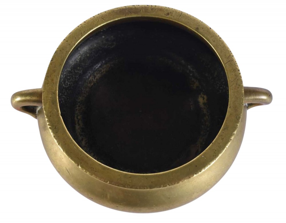 An 18th-century cast bronze incense burner featuring a compressed rounded body, flared rim, two loop handles, and a burnished golden patinated finish. View VI