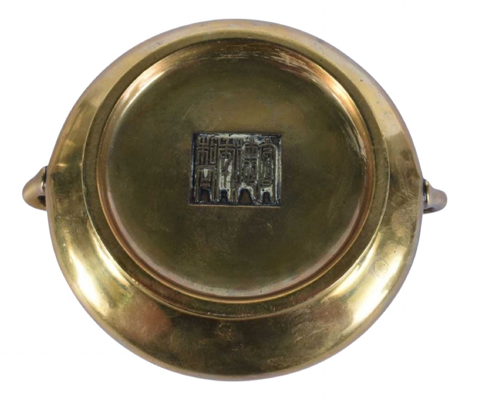 An 18th-century cast bronze incense burner featuring a compressed rounded body, flared rim, two loop handles, and a burnished golden patinated finish. View VII