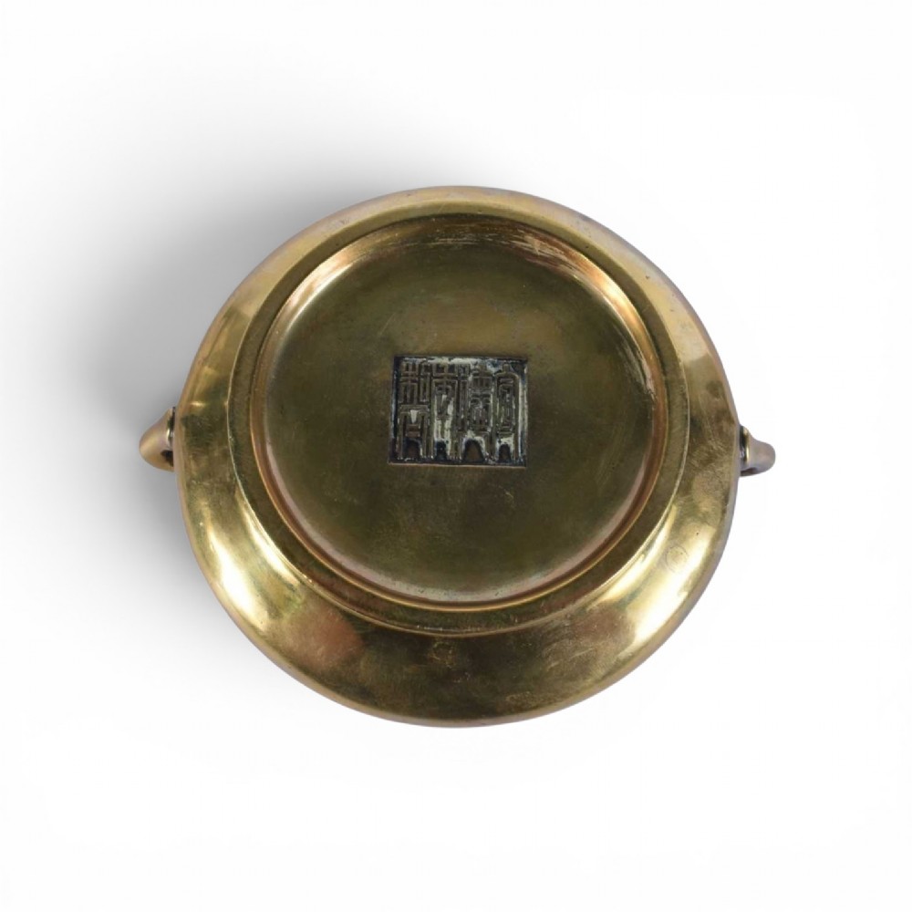 An 18th-century cast bronze incense burner featuring a compressed rounded body, flared rim, two loop handles, and a burnished golden patinated finish. View VIII