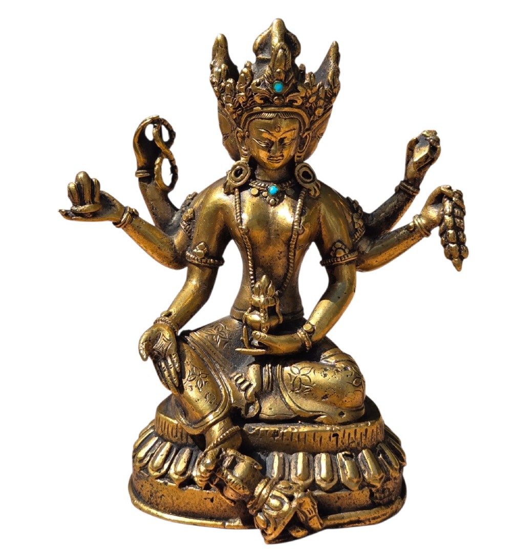 An early 19th-century gilt bronze multi-armed deity figure seated on a lotus base with turquoise stone inlays in the crown. View III