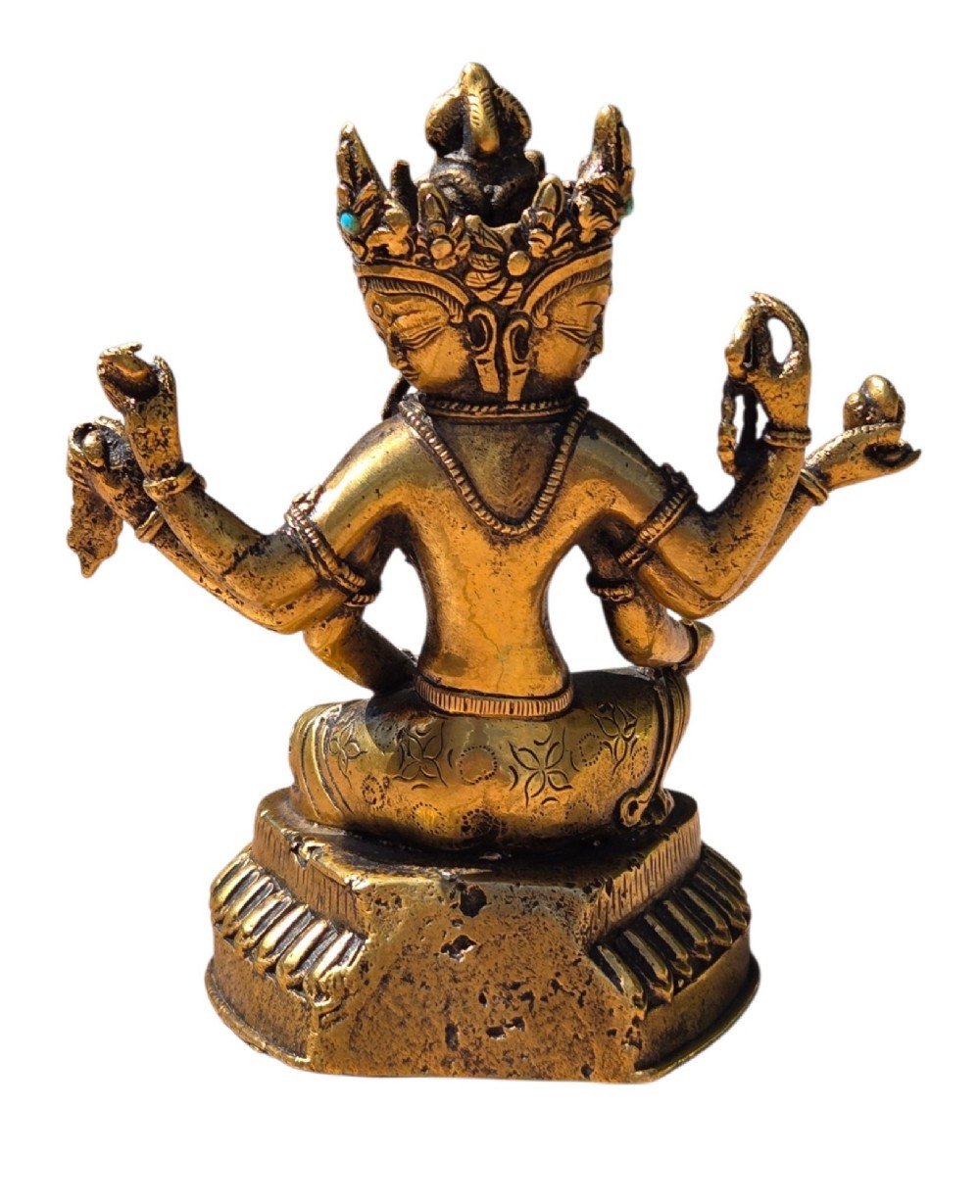 An early 19th-century gilt bronze multi-armed deity figure seated on a lotus base with turquoise stone inlays in the crown. View VII
