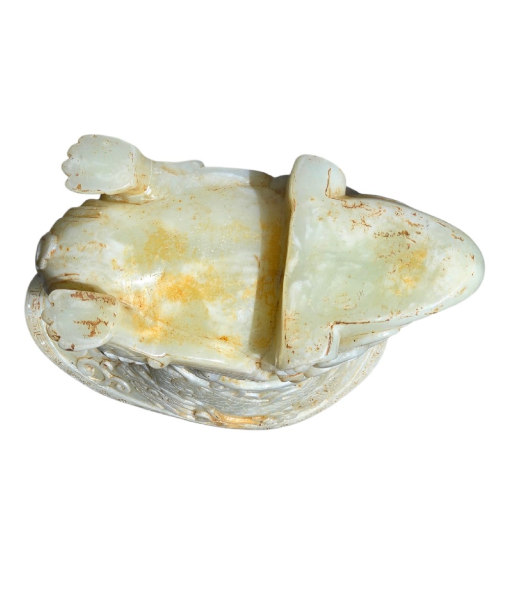 A carved pale celadon nephrite jade rhyton cup featuring relief dragon and mythical beast motifs with subtle russet inclusions. View VII