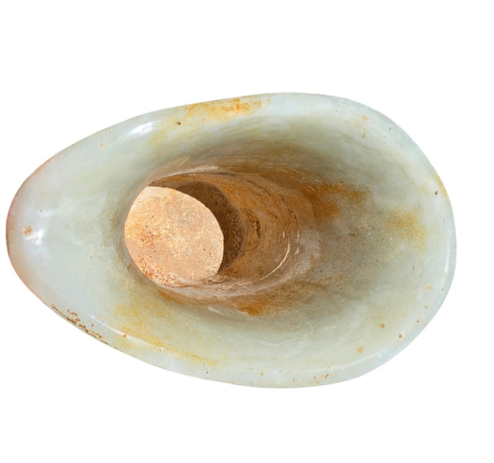 A carved pale celadon nephrite jade rhyton cup featuring relief dragon and mythical beast motifs with subtle russet inclusions. View VIII