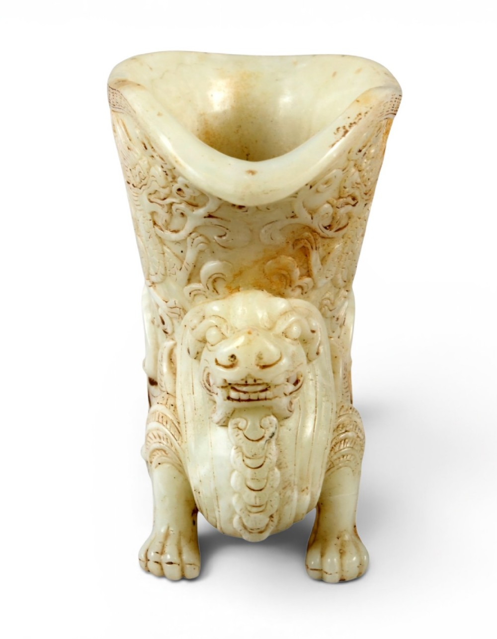 A carved pale celadon nephrite jade rhyton cup featuring relief dragon and mythical beast motifs with subtle russet inclusions. View XIV