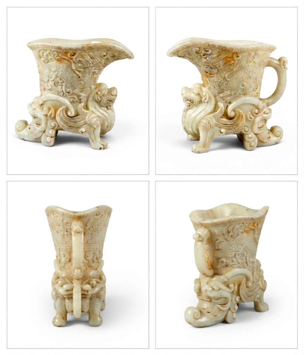 A carved pale celadon nephrite jade rhyton cup featuring relief dragon and mythical beast motifs with subtle russet inclusions. View XV