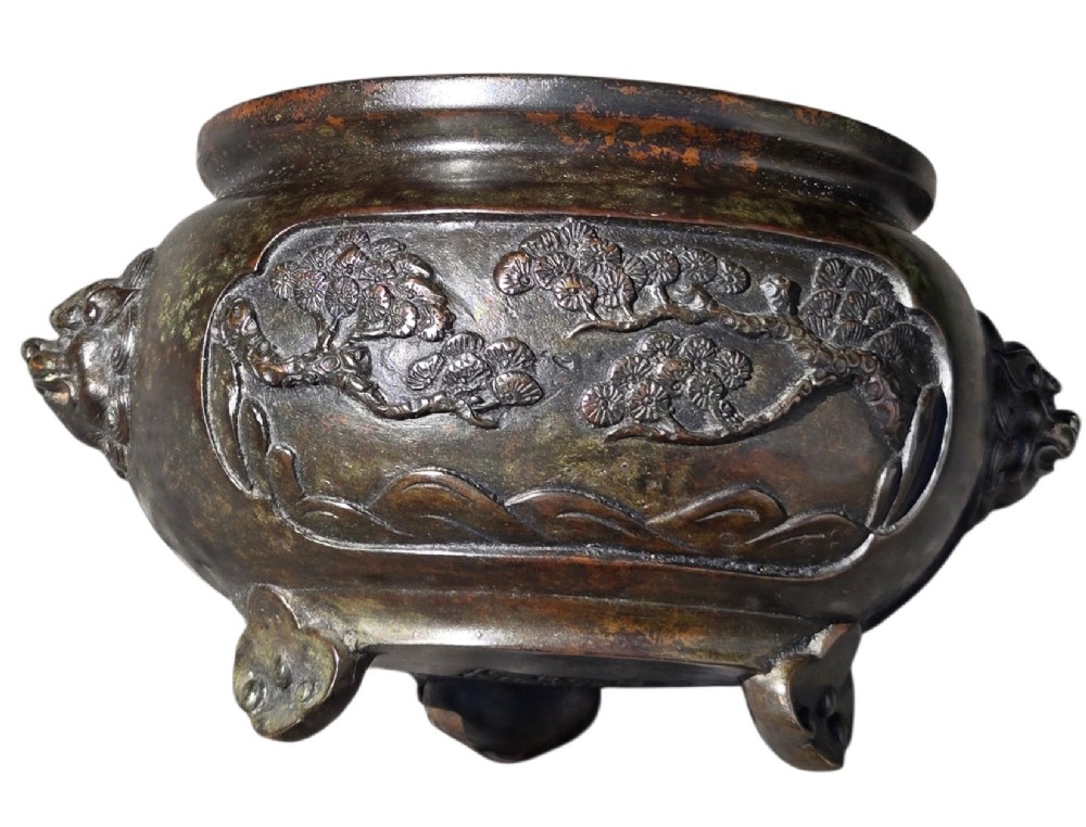 A dark patinated cast bronze incense burner featuring raised relief panels of bamboo and beast mask side handles. View VII
