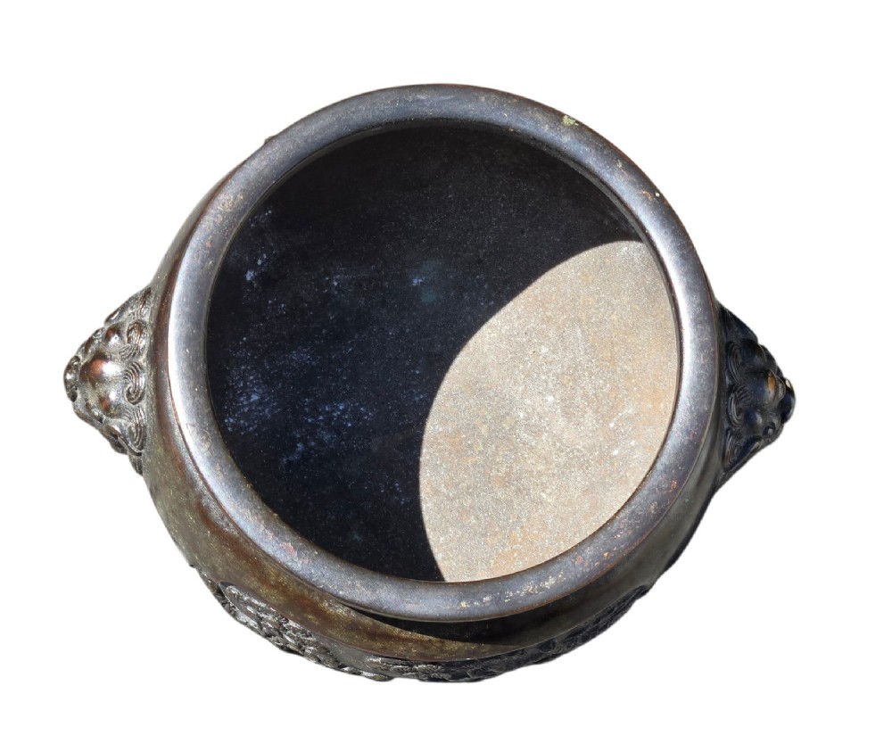 A dark patinated cast bronze incense burner featuring raised relief panels of bamboo and beast mask side handles. View XII
