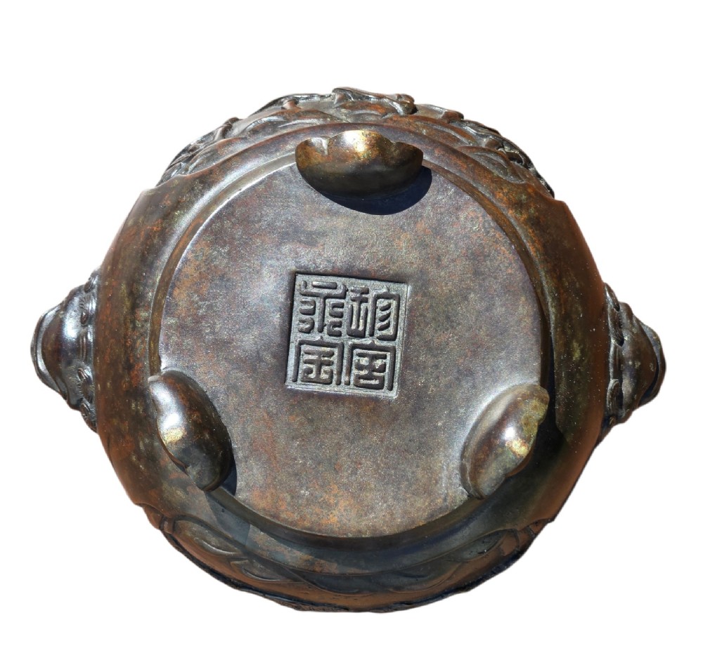 A dark patinated cast bronze incense burner featuring raised relief panels of bamboo and beast mask side handles. View XIII