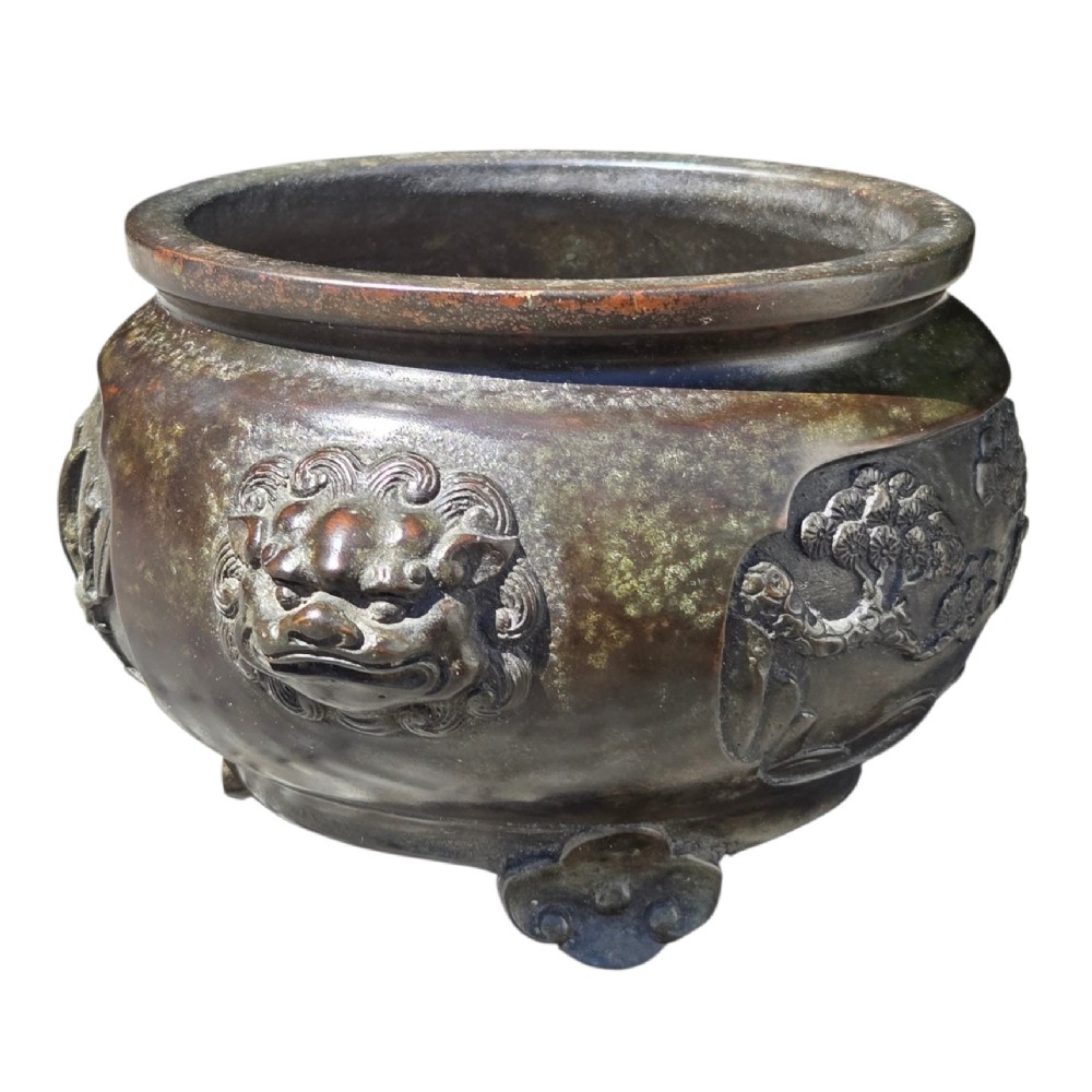 A dark patinated cast bronze incense burner featuring raised relief panels of bamboo and beast mask side handles. View XV