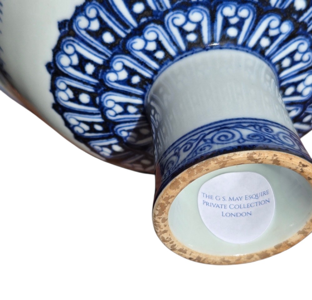A Chinese blue and white porcelain stem cup featuring Tibetan script around the exterior flared bowl and a hollow cylindrical foot. View VIII