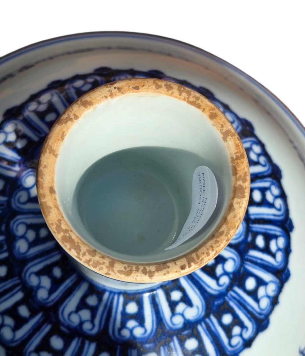 A Chinese blue and white porcelain stem cup featuring Tibetan script around the exterior flared bowl and a hollow cylindrical foot. View IX