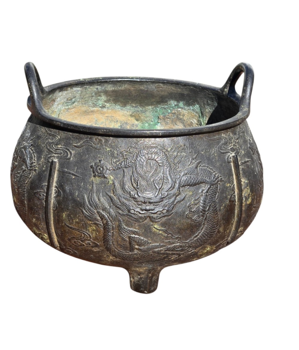 A dark cast bronze tripod censer with loop handles, low feet, and dragon motifs in relief across the exterior. View IV