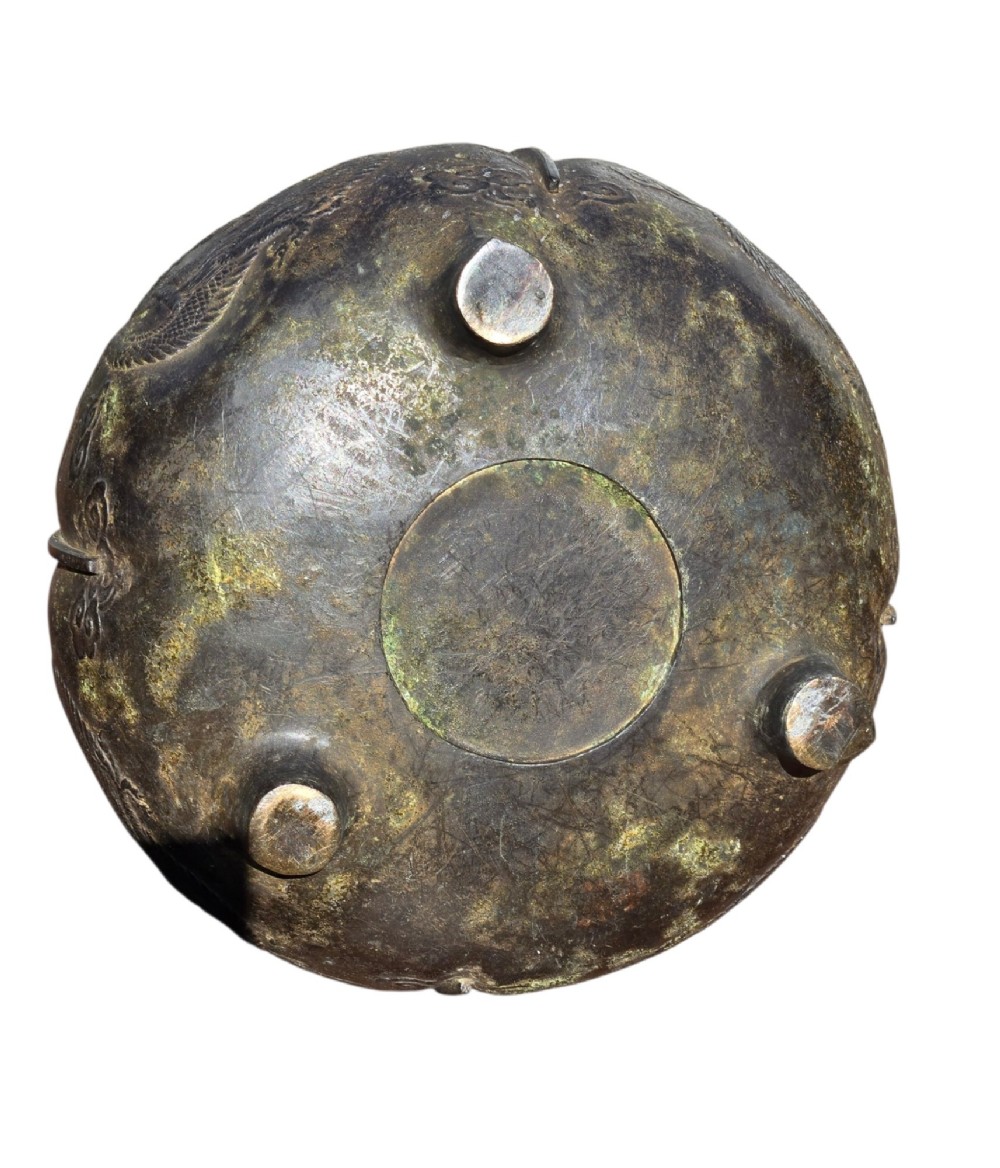 A dark cast bronze tripod censer with loop handles, low feet, and dragon motifs in relief across the exterior. View VIII