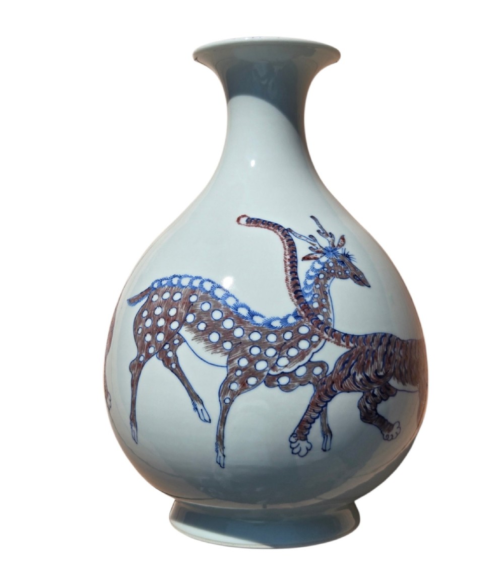 A white porcelain garlic-mouth vase featuring underglaze blue and copper-red painted depictions of mythical beasts. View III