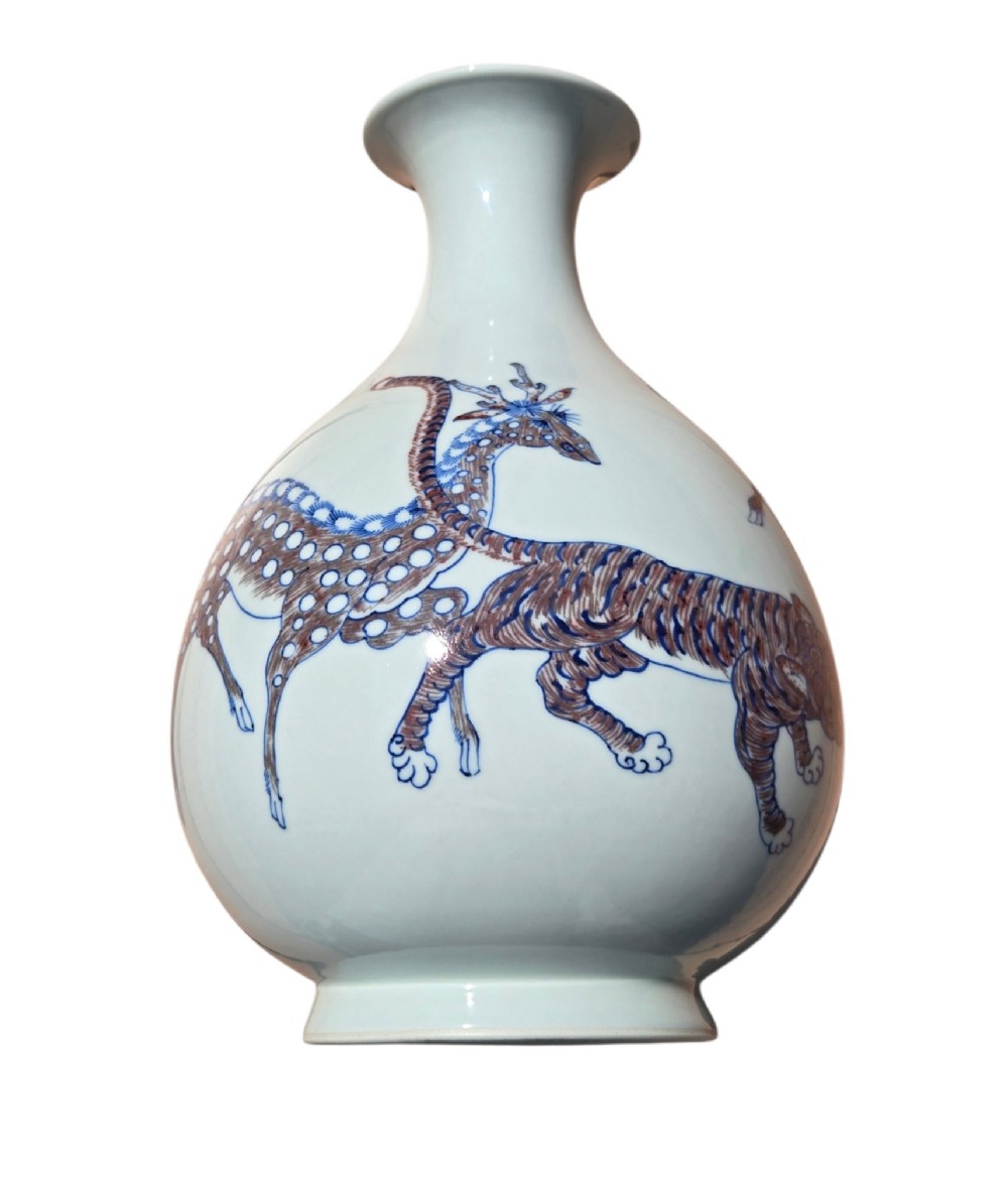A white porcelain garlic-mouth vase featuring underglaze blue and copper-red painted depictions of mythical beasts. View V