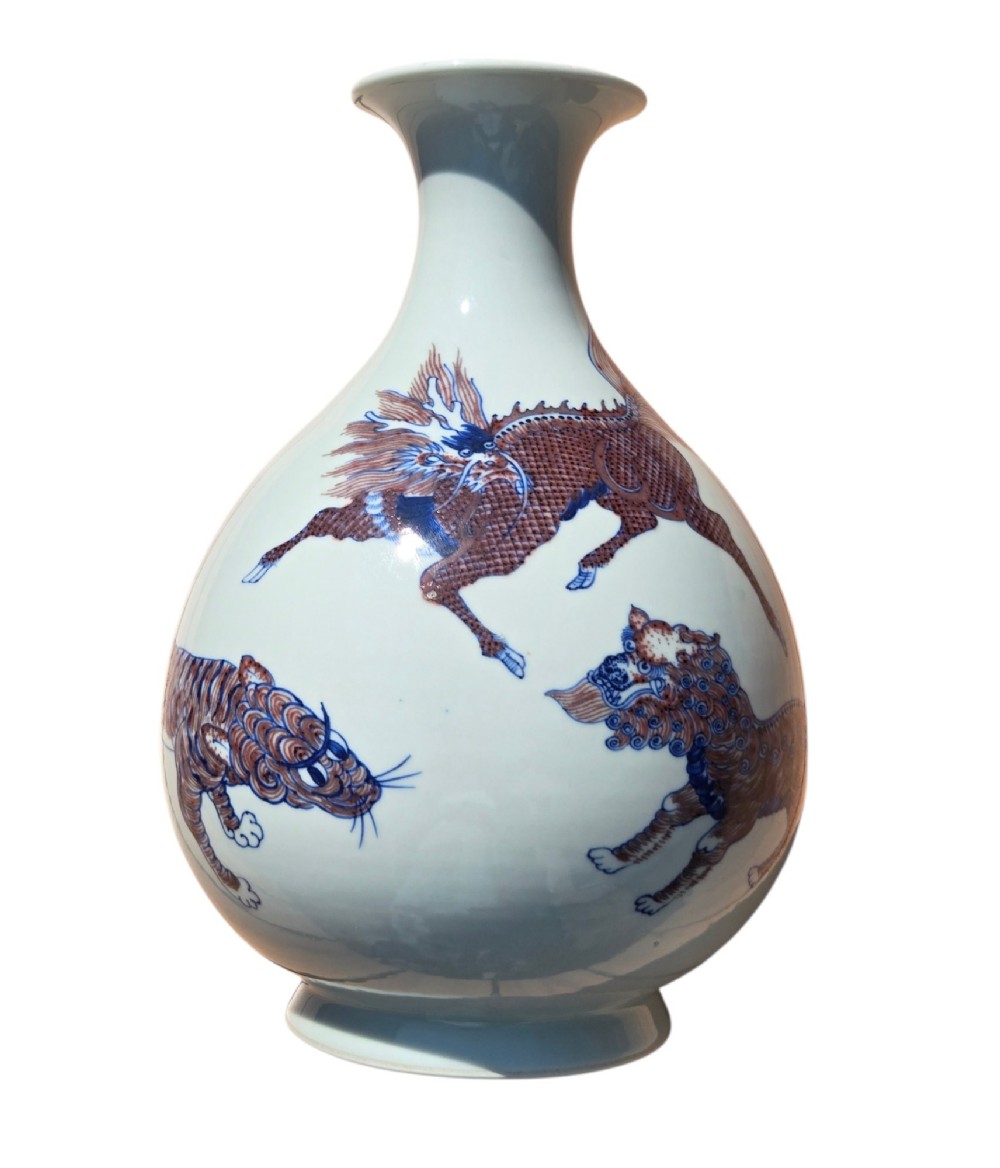 A white porcelain garlic-mouth vase featuring underglaze blue and copper-red painted depictions of mythical beasts. View VI
