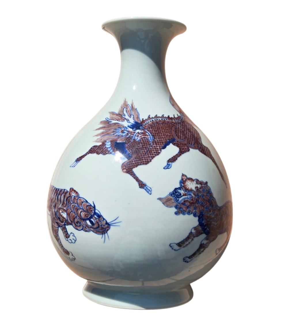 A white porcelain garlic-mouth vase featuring underglaze blue and copper-red painted depictions of mythical beasts. View VII