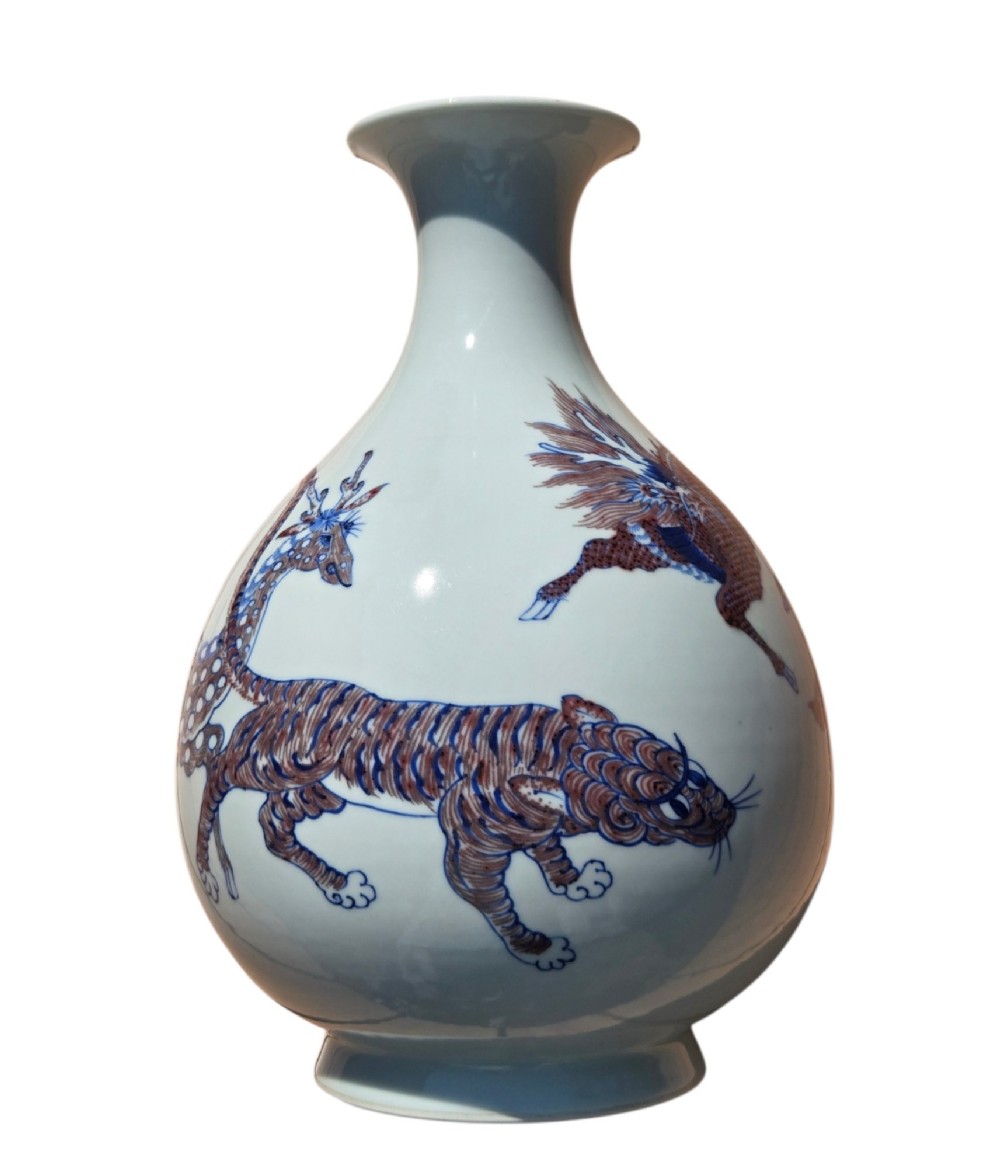 A white porcelain garlic-mouth vase featuring underglaze blue and copper-red painted depictions of mythical beasts. View VIII