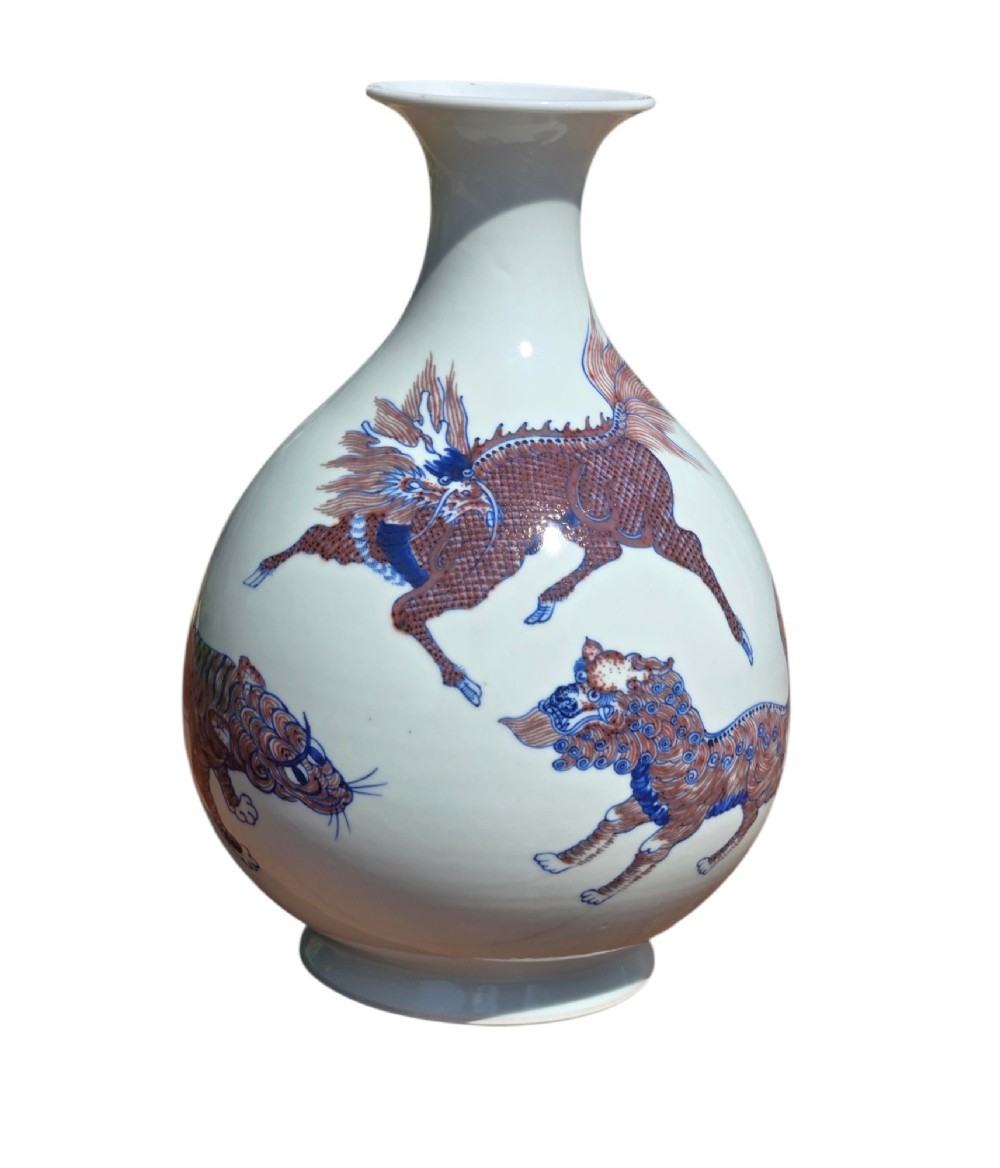 A white porcelain garlic-mouth vase featuring underglaze blue and copper-red painted depictions of mythical beasts. View XI