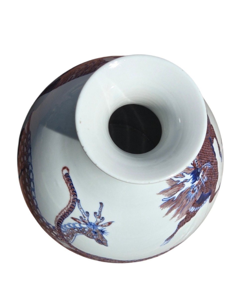 A white porcelain garlic-mouth vase featuring underglaze blue and copper-red painted depictions of mythical beasts. View XII