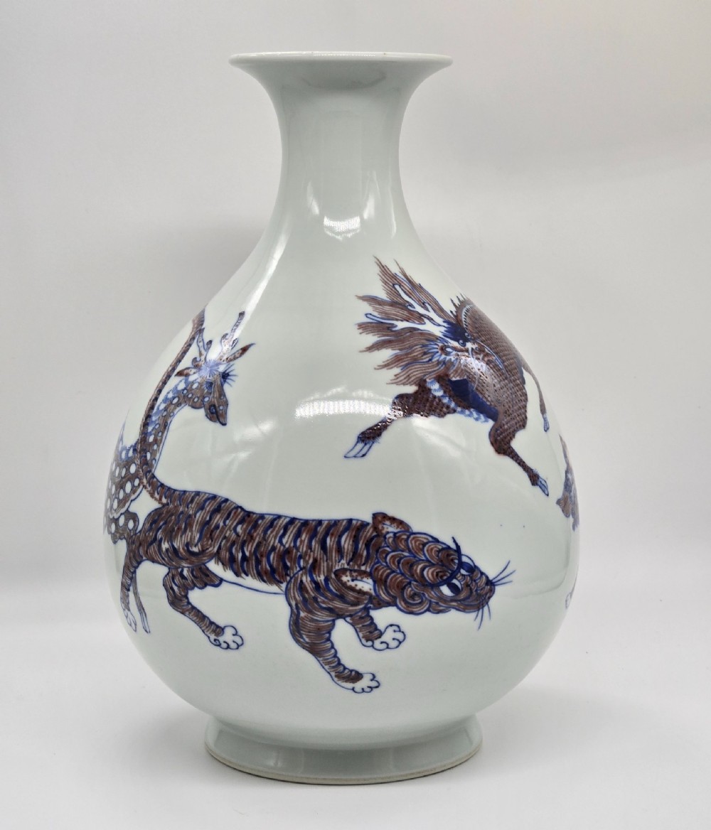 A white porcelain garlic-mouth vase featuring underglaze blue and copper-red painted depictions of mythical beasts. View XIV