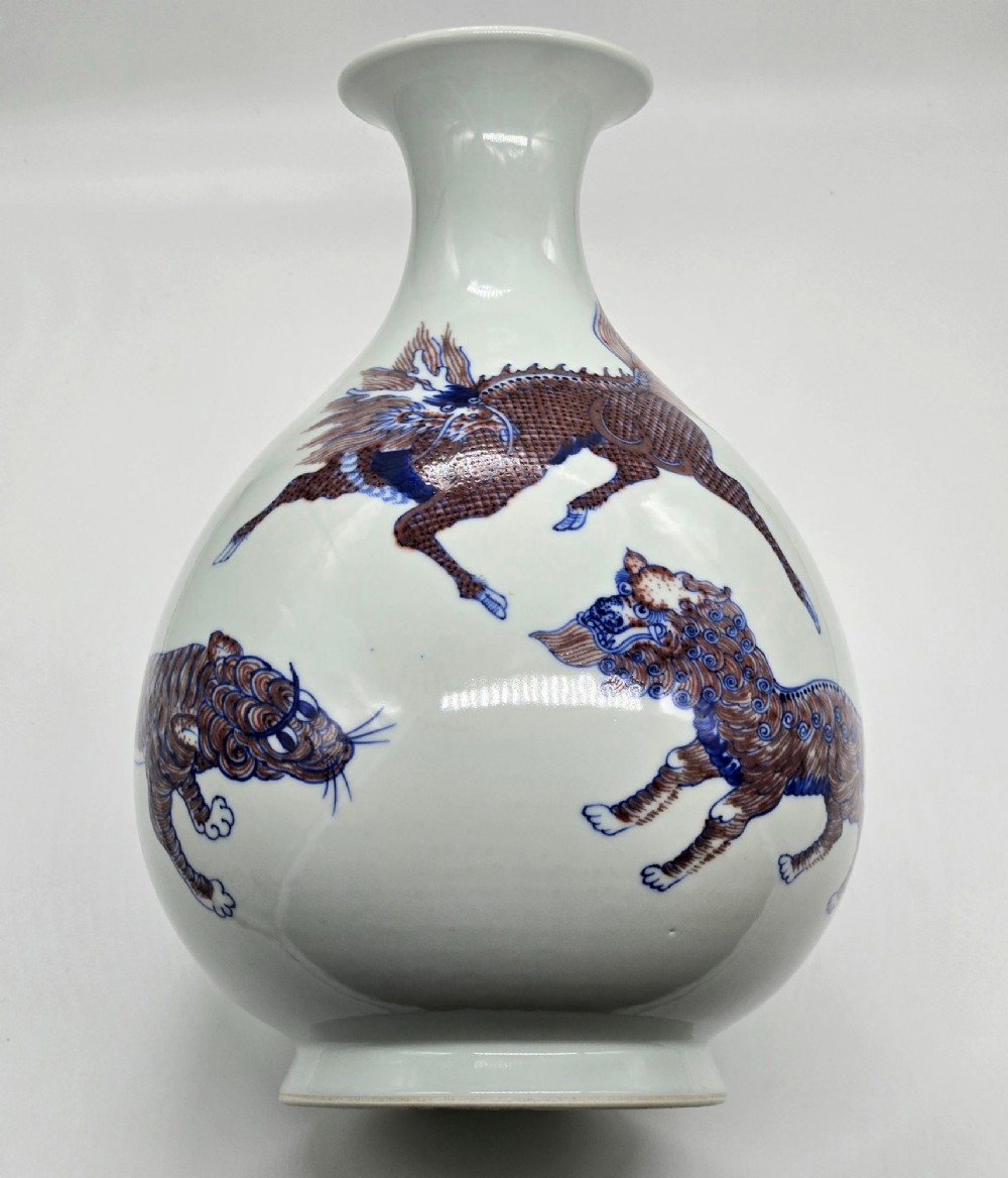 A white porcelain garlic-mouth vase featuring underglaze blue and copper-red painted depictions of mythical beasts. View XV
