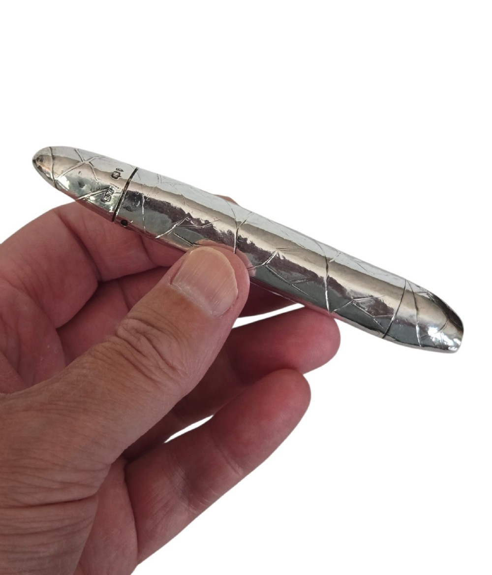 A Victorian sterling silver vesta case crafted in the shape of a double-ended cigar with engraved leaf textures. View III