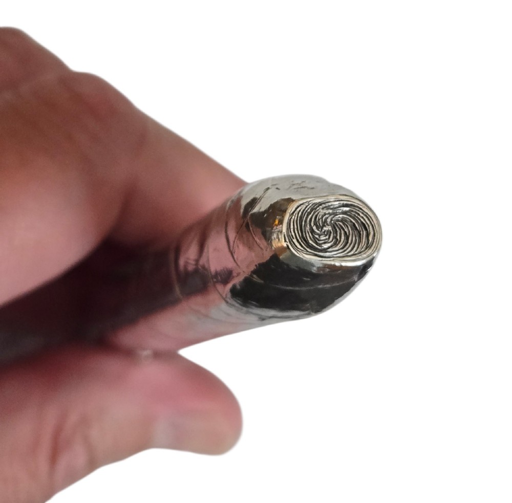 A Victorian sterling silver vesta case crafted in the shape of a double-ended cigar with engraved leaf textures. View IX