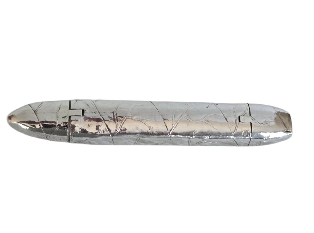 A Victorian sterling silver vesta case crafted in the shape of a double-ended cigar with engraved leaf textures. View X