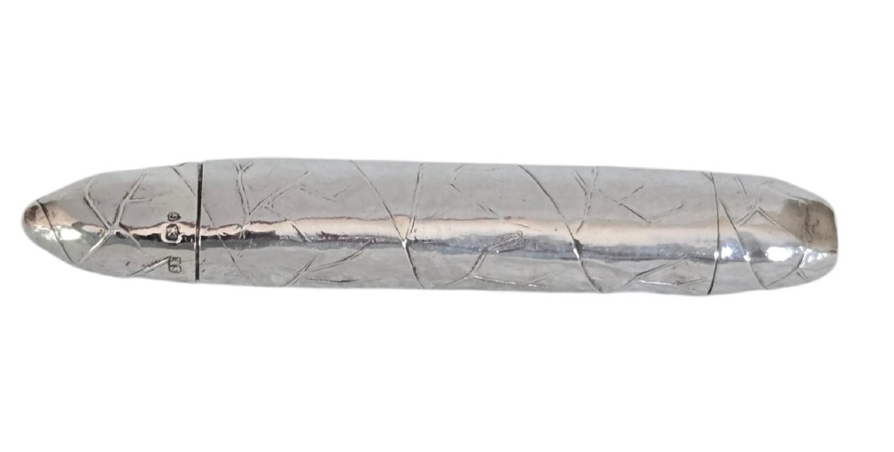 A Victorian sterling silver vesta case crafted in the shape of a double-ended cigar with engraved leaf textures. View XI