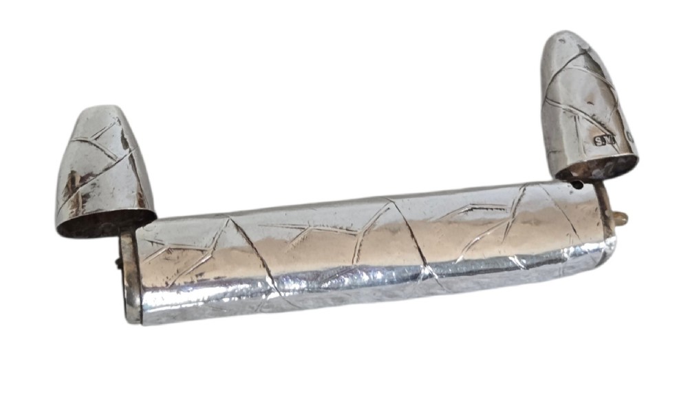 A Victorian sterling silver vesta case crafted in the shape of a double-ended cigar with engraved leaf textures. View XII