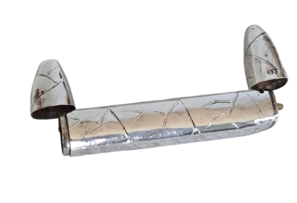 A Victorian sterling silver vesta case crafted in the shape of a double-ended cigar with engraved leaf textures. View XIV