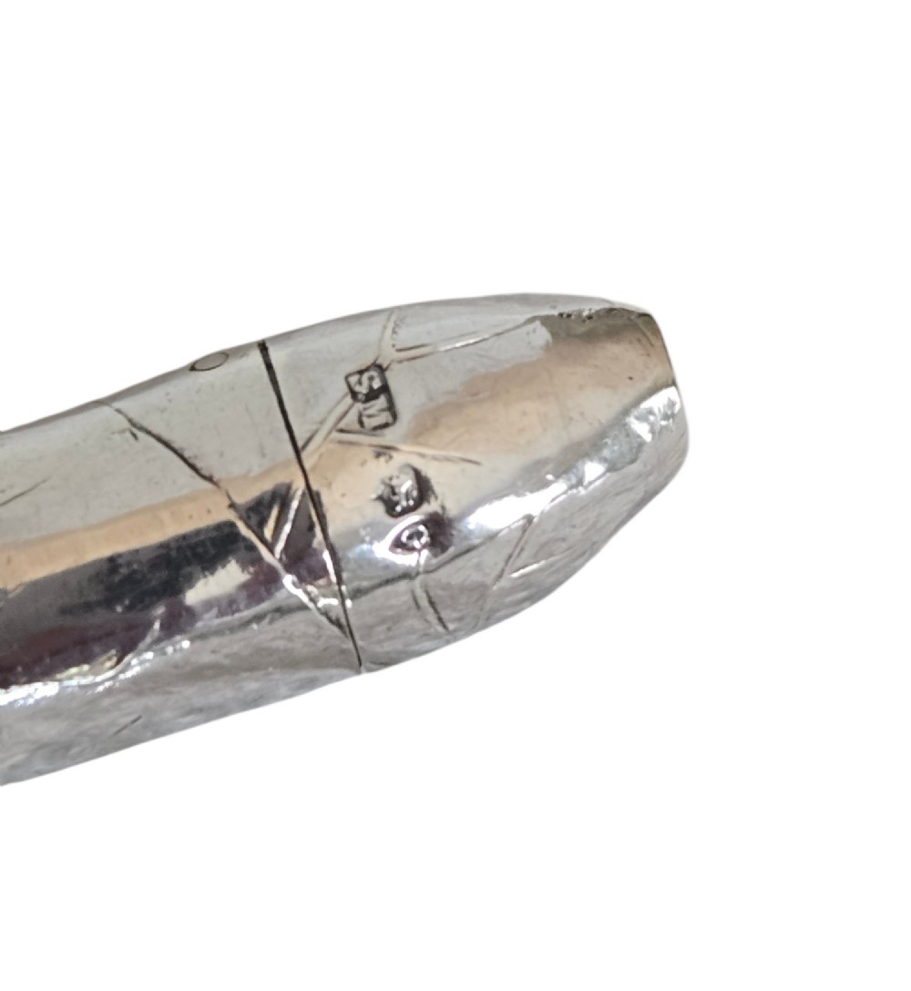 A Victorian sterling silver vesta case crafted in the shape of a double-ended cigar with engraved leaf textures. View XV