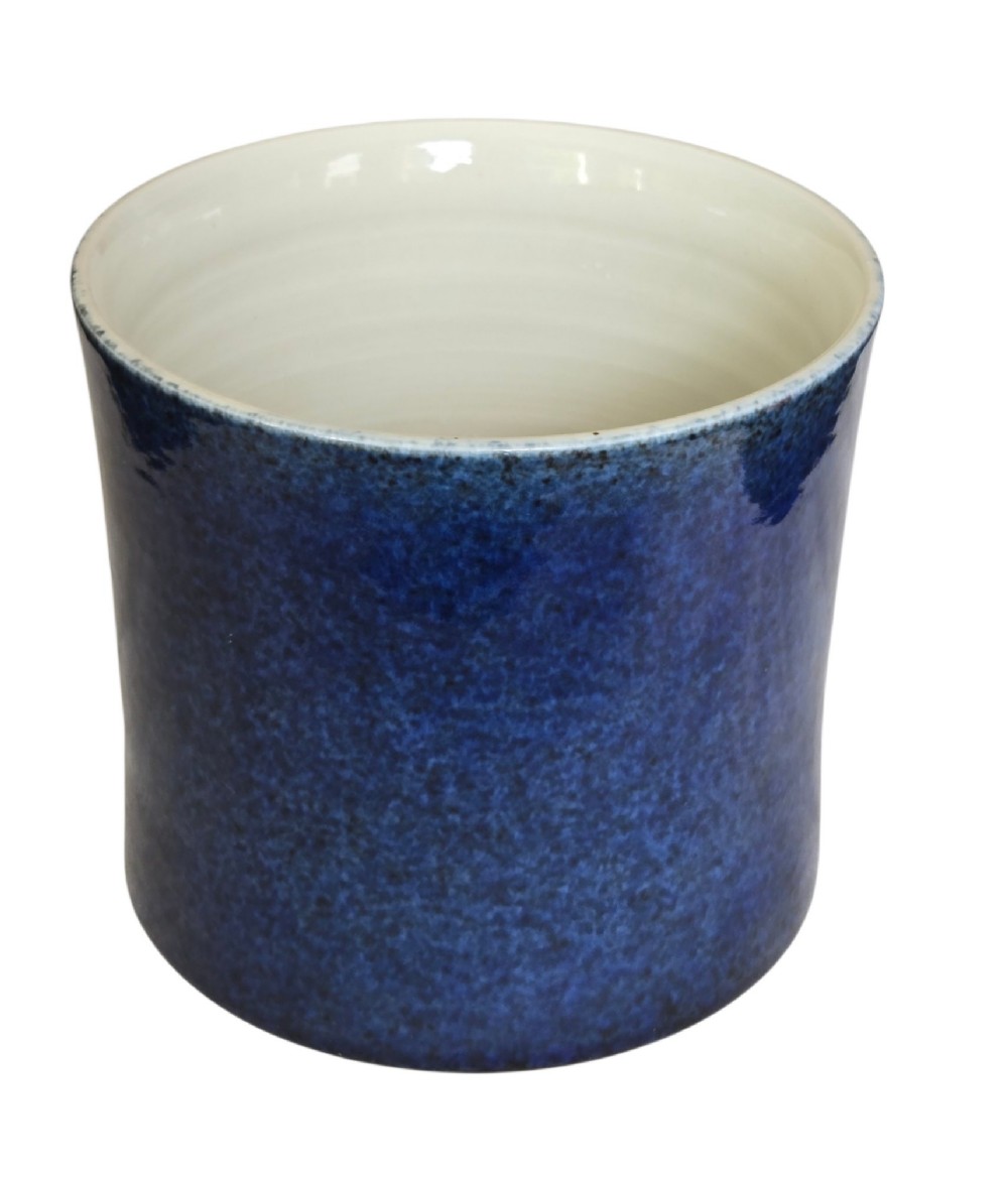 A cylindrical Chinese porcelain brush pot featuring a mottled powder-blue glaze with a pale rim. View IV