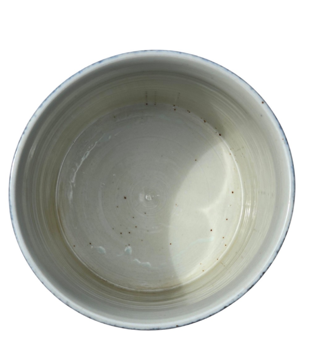 A cylindrical Chinese porcelain brush pot featuring a mottled powder-blue glaze with a pale rim. View VIII