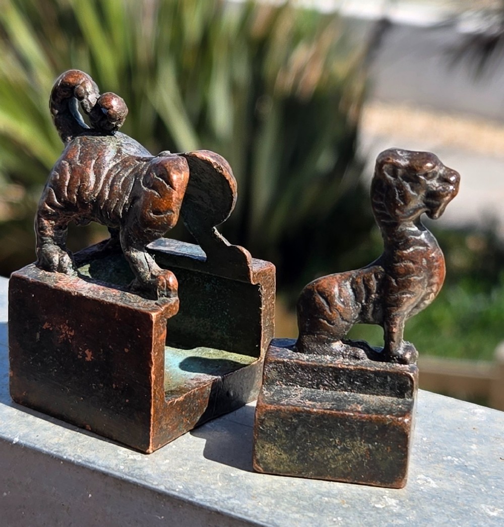 A cast bronze Chinese seal featuring a qilin finial resting atop a square base with reddish brown patination. View II