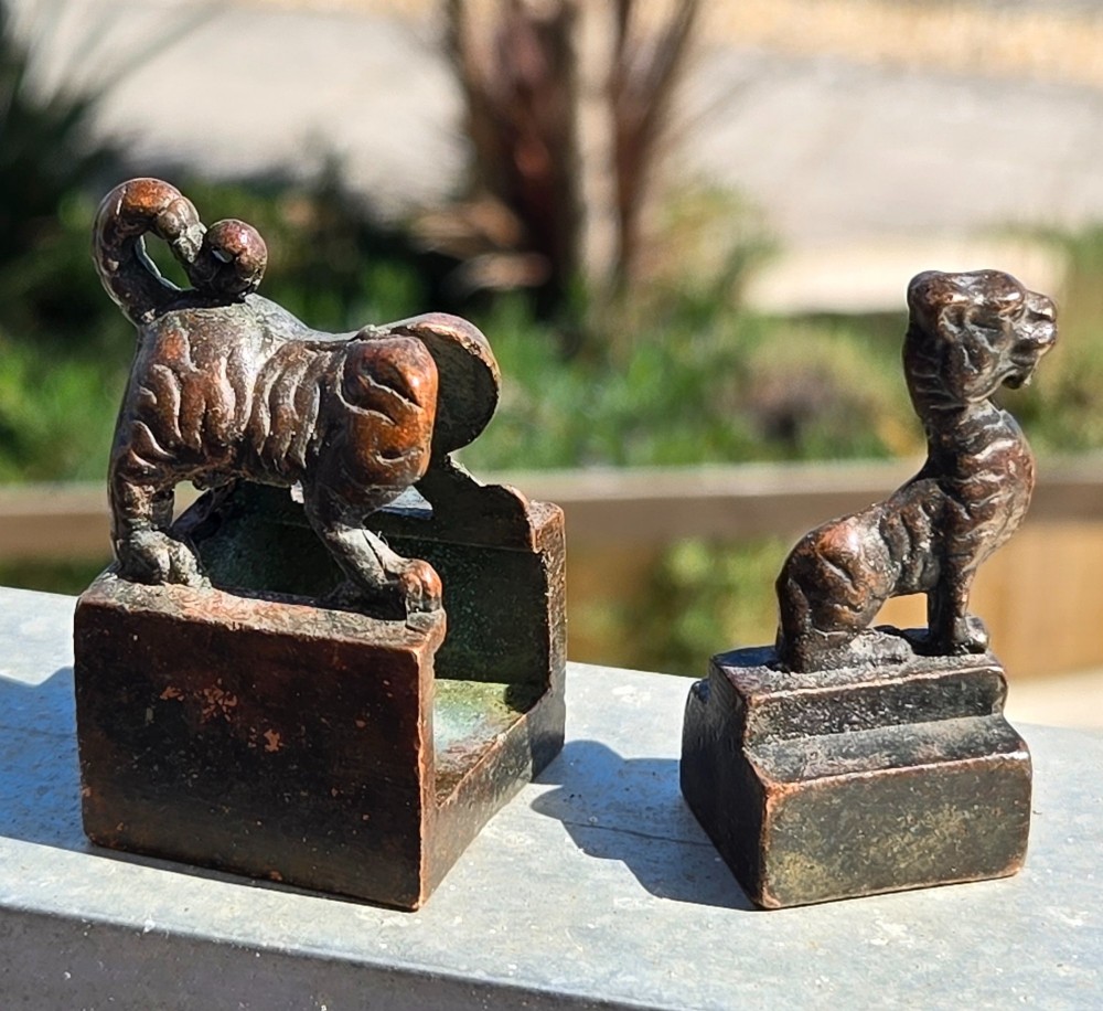 A cast bronze Chinese seal featuring a qilin finial resting atop a square base with reddish brown patination. View III