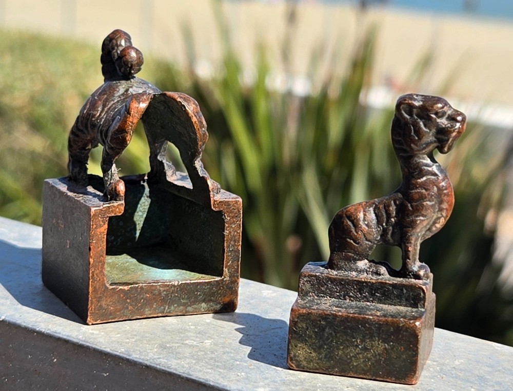 A cast bronze Chinese seal featuring a qilin finial resting atop a square base with reddish brown patination. View V