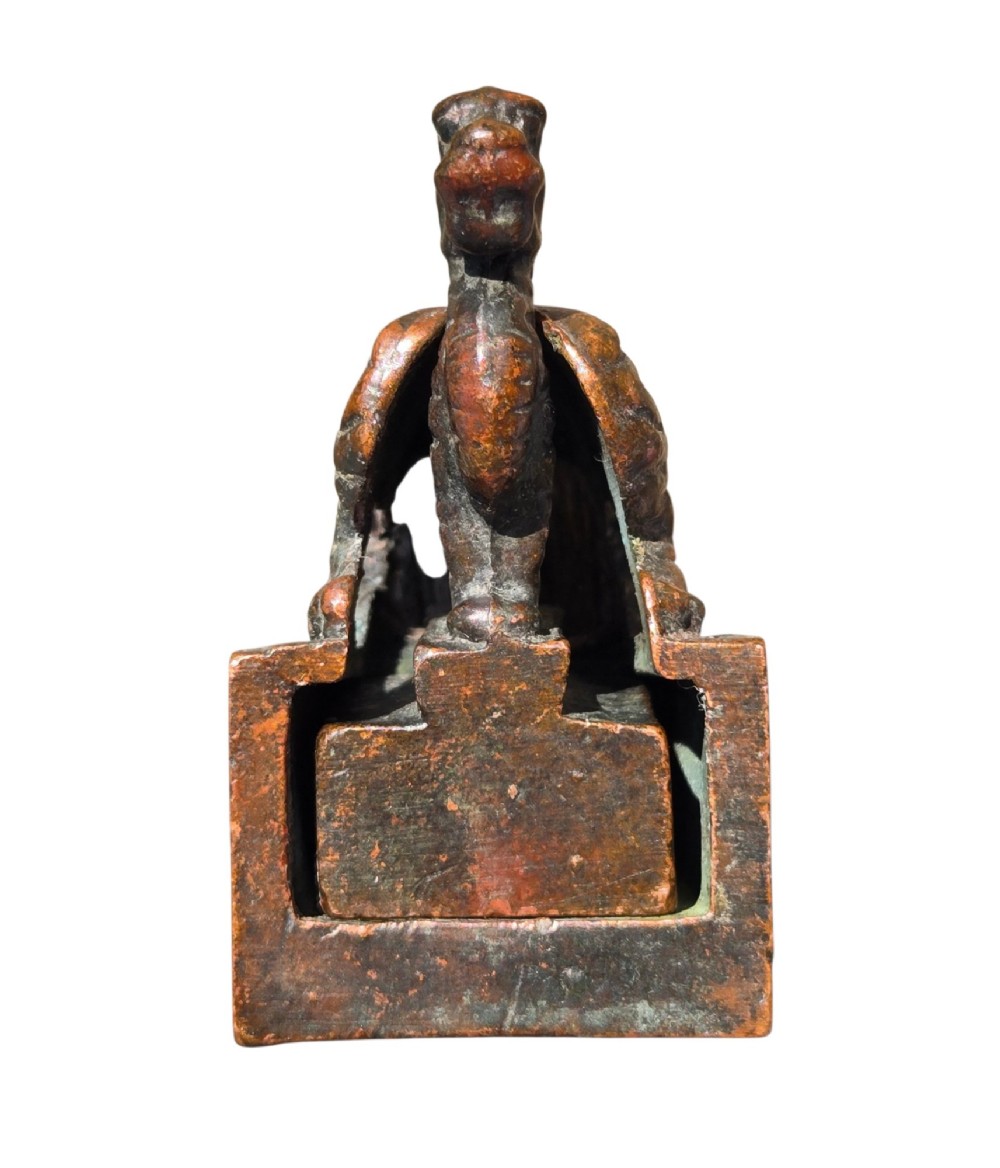 A cast bronze Chinese seal featuring a qilin finial resting atop a square base with reddish brown patination. View VIII