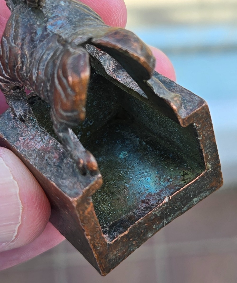 A cast bronze Chinese seal featuring a qilin finial resting atop a square base with reddish brown patination. View XIV