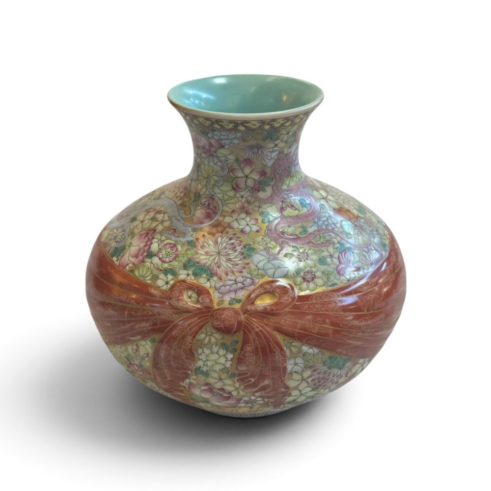 A spherical porcelain vase decorated with a dense millefleurs floral pattern, dual dragon motifs, a tied iron-red ribbon motif, and a turquoise interior rim. View III