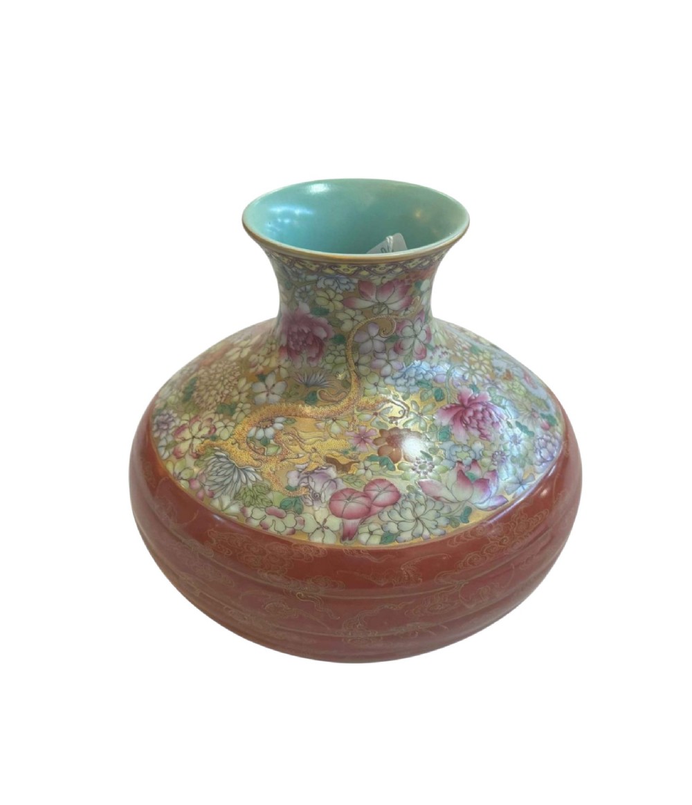 A spherical porcelain vase decorated with a dense millefleurs floral pattern, dual dragon motifs, a tied iron-red ribbon motif, and a turquoise interior rim. View VII
